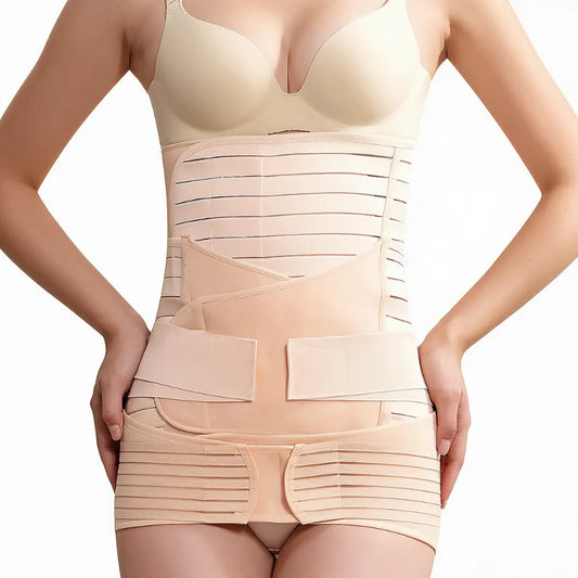 Front view of a woman wearing a postpartum support belly wrap after a C-section delivery against a white background.