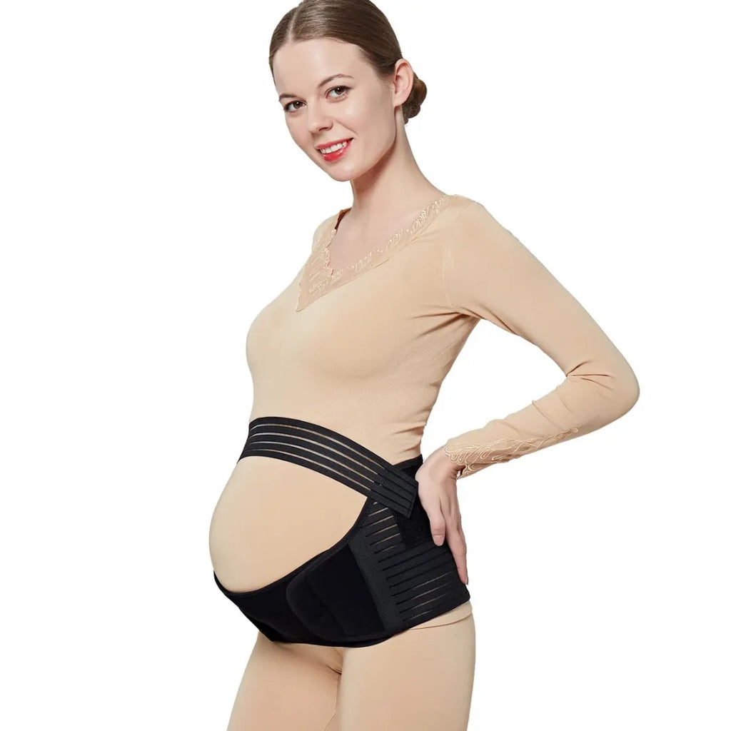 right-side view of a smiling pregnant woman wearing a black baby bump support belt for maternity comfort.