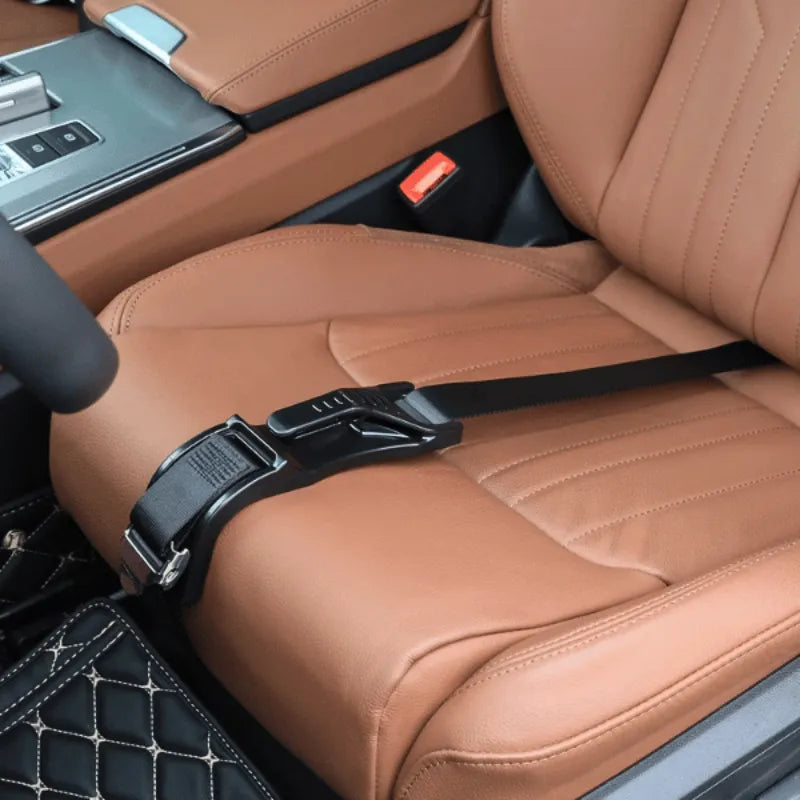 Close-up of a black seat belt extender clipped onto a brown leather car seat.