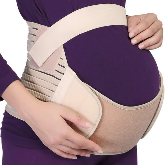   A maternity belly support band in beige color worn by pregnant women; it is an adjustable and breathable comfort belt.